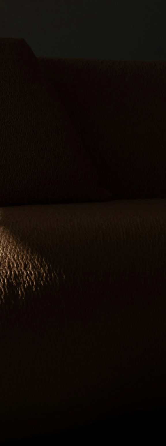 Light falling across a deep sofa cushion